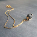 Matte Black Stone Necklace, eclipse necklace, snowflake obsidian necklace, spotted obsidian pendant, gold semicircle, modern half circle orb - Constant Baubling