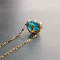 Eclipse Necklace, gold over blue glass ball necklace, gold spinner necklace, goil flake foil, mottled turquoise bead, teal glass bead, Earth