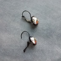 Bunny Earrings, leaping rabbit earring, Easter jewelry, round print under glass on black lever back hooks, snap close leverback, runaway