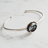 Silver Cuff Bracelet - oval open bangle w/ antiqued oxidized finish - thick simple wire w/ glass swirl ocean waves art in round deep bezel - Constant Baubling