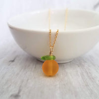 Orange Necklace, small fruit pendant, green leaf charm, orange jewelry, glass orange, translucent orange, Florida fruit, simple gold chain - Constant Baubling