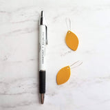 Yellow Earrings - goldenrod/mustard faux vegan leather leaf shape drop on silver kidney wire hooks - plain pointed oval spheroid charm - Constant Baubling