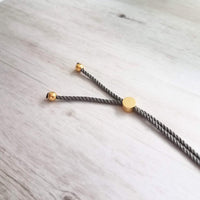 Gold Feather Bracelet, grey cord bracelet, gray gold bracelet, thin bracelet, stacking bracelet, twisted bracelet, minimalist, simple charm - Constant Baubling