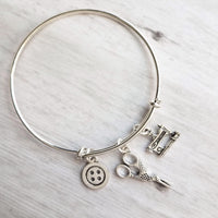 Sewing Charm Bracelet - seamstress hobby/tailor gift - silver adjustable bangle double loop wire w/ tiny sewing machine, scissors, button - Constant Baubling