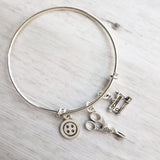 Sewing Charm Bracelet - seamstress hobby/tailor gift - silver adjustable bangle double loop wire w/ tiny sewing machine, scissors, button - Constant Baubling