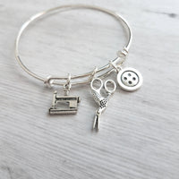 Sewing Charm Bracelet - seamstress hobby/tailor gift - silver adjustable bangle double loop wire w/ tiny sewing machine, scissors, button - Constant Baubling