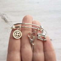 Sewing Charm Bracelet - seamstress hobby/tailor gift - silver adjustable bangle double loop wire w/ tiny sewing machine, scissors, button - Constant Baubling