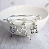 Sewing Charm Bracelet - seamstress hobby/tailor gift - silver adjustable bangle double loop wire w/ tiny sewing machine, scissors, button - Constant Baubling