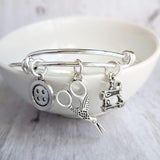 Sewing Charm Bracelet - seamstress hobby/tailor gift - silver adjustable bangle double loop wire w/ tiny sewing machine, scissors, button - Constant Baubling