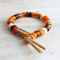 Autumn Bracelet - orange, tan, brown glass big bead tie on faux suede cord, chunky glass pony roller beads, VSCO girl, fall color jewelry - Constant Baubling