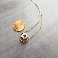 Eclipse Necklace - black white spotted round stone in semicircle pendant, Tibetan Dzi agate bead ball, giraffe print in gold half circle - Constant Baubling