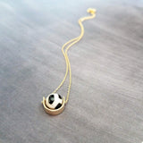 Eclipse Necklace - black white spotted round stone in semicircle pendant, Tibetan Dzi agate bead ball, giraffe print in gold half circle - Constant Baubling
