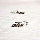 Seahorse Earrings - little tiny black gunmetal silver charms dangle on small simple shiny delicate hooks, minimalist tropical beach memento - Constant Baubling