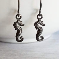 Seahorse Earrings - little tiny black gunmetal silver charms dangle on small simple shiny delicate hooks, minimalist tropical beach memento - Constant Baubling