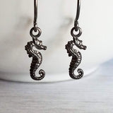 Seahorse Earrings - little tiny black gunmetal silver charms dangle on small simple shiny delicate hooks, minimalist tropical beach memento - Constant Baubling
