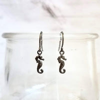 Seahorse Earrings - little tiny black gunmetal silver charms dangle on small simple shiny delicate hooks, minimalist tropical beach memento - Constant Baubling