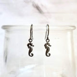 Seahorse Earrings - little tiny black gunmetal silver charms dangle on small simple shiny delicate hooks, minimalist tropical beach memento - Constant Baubling