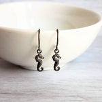 Seahorse Earrings - little tiny black gunmetal silver charms dangle on small simple shiny delicate hooks, minimalist tropical beach memento - Constant Baubling