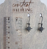 Black Star Earrings, small matte black sunburst charm, latching kidney hooks, night earrings, celestial earring starburst earring north star - Constant Baubling