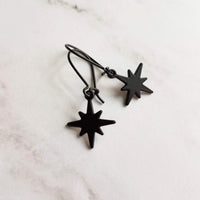 Black Star Earrings, small matte black sunburst charm, latching kidney hooks, night earrings, celestial earring starburst earring north star - Constant Baubling