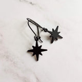 Black Star Earrings, small matte black sunburst charm, latching kidney hooks, night earrings, celestial earring starburst earring north star - Constant Baubling
