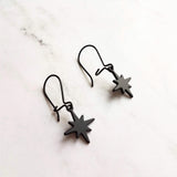 Black Star Earrings, small matte black sunburst charm, latching kidney hooks, night earrings, celestial earring starburst earring north star - Constant Baubling