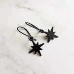 Black Star Earrings, small matte black sunburst charm, latching kidney hooks, night earrings, celestial earring starburst earring north star - Constant Baubling