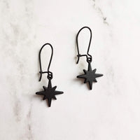 Black Star Earrings, small matte black sunburst charm, latching kidney hooks, night earrings, celestial earring starburst earring north star - Constant Baubling