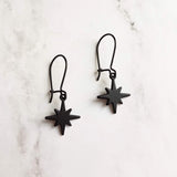 Black Star Earrings, small matte black sunburst charm, latching kidney hooks, night earrings, celestial earring starburst earring north star - Constant Baubling