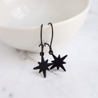 Black Star Earrings, small matte black sunburst charm, latching kidney hooks, night earrings, celestial earring starburst earring north star - Constant Baubling