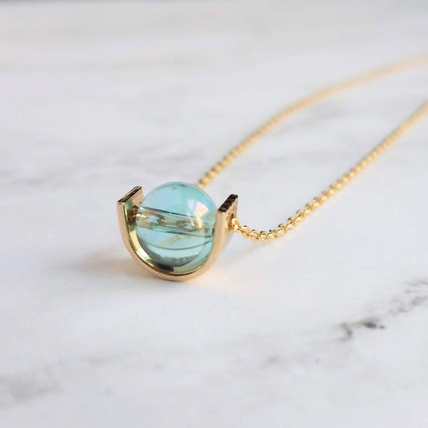 Modern Gold Necklace, blue glass pendant, spinner necklace, orb