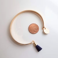 Gold Cuff Bracelet, initial bracelet, gold letter bracelet, gold tassel bracelet, thin gold cuff, navy blue tassel cuff, letter charm bangle - Constant Baubling