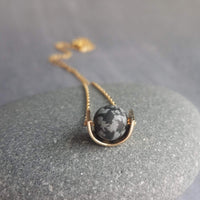 Matte Black Stone Necklace, eclipse necklace, snowflake obsidian necklace, spotted obsidian pendant, gold semicircle, modern half circle orb - Constant Baubling